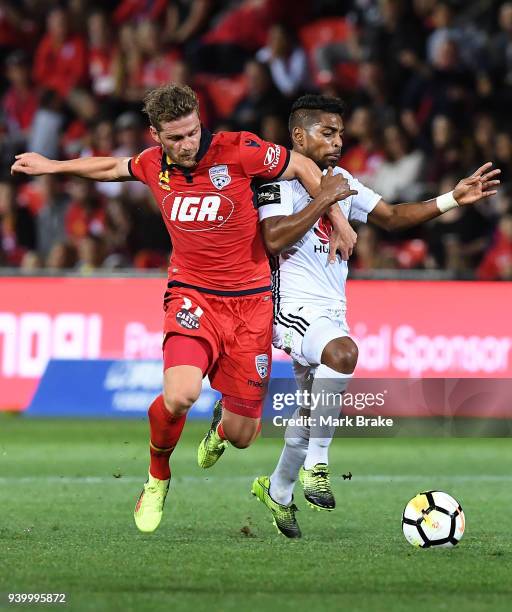 Roy Krishna of Wellington Phoenix deliberatley fouls Johan Absalonsen of Adelaide United and is yellow carded during the round 25 A-League match...
