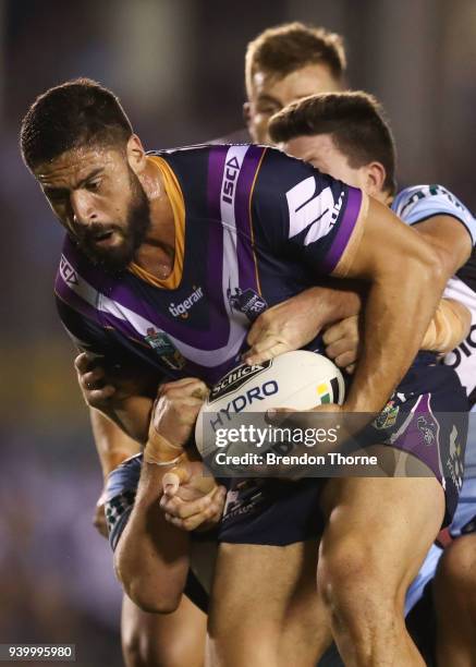 Jesse Bromwich of the Storm is tackled by the Sharks defence during the round four NRL match between the Cronulla Sharks and the Melbourne Storm at...