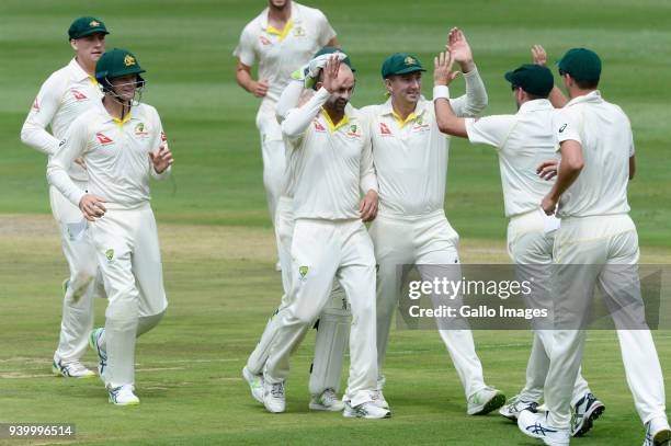 Nathan Lyon of Australia celebrates the wicket of Dean Elgar of the Proteas with his team mates during day 1 of the 4th Sunfoil Test match between...