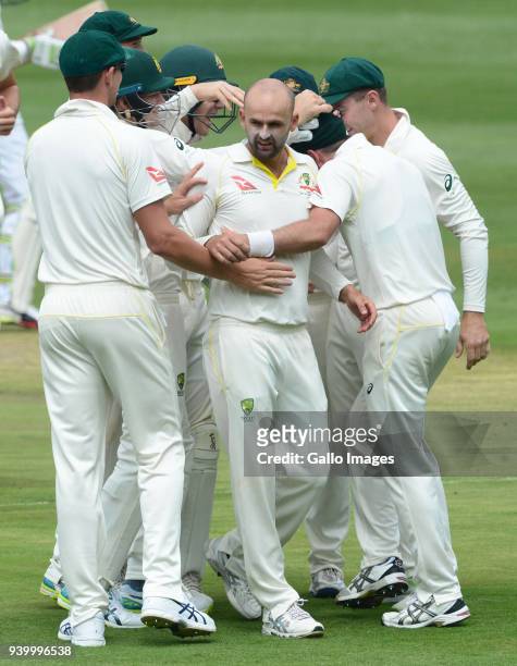 Nathan Lyon of Australia celebrates the wicket of Dean Elgar of the Proteas with his team mates during day 1 of the 4th Sunfoil Test match between...