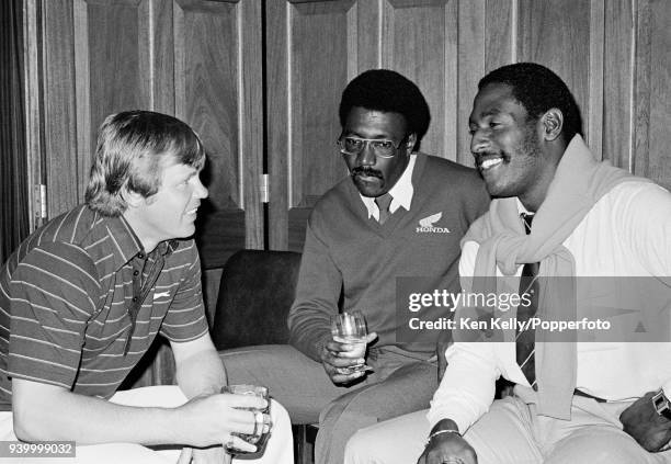 Gloucestershire's South African captain Mike Procter has a drink and a chat with Clive Lloyd and Viv Richards of West Indies after the tour match...