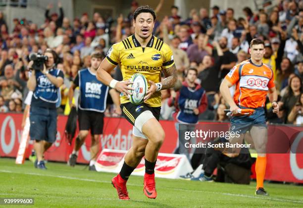 Ben Lam of the Hurricanes runs in to score a try during the round seven Super Rugby match between the Rebels and the Hurricanes at AAMI Park on March...