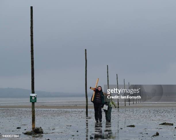 Pilgrims celebrate Easter by crossing over the tidal causeway carrying wooden crosses on the final leg of their annual pilgrimage to the Holy Island...