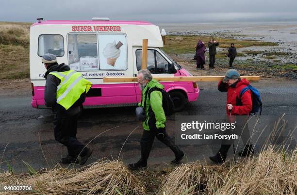 Pilgrims celebrate Easter by crossing over the tidal causeway carrying wooden crosses on the final leg of their annual pilgrimage to the Holy Island...