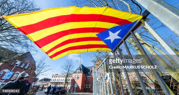 Catalan pro-independence Estelada flag is attached to a fence in front of the prison on March 30, 2018 in Neumuenster, northern Germany, where former...
