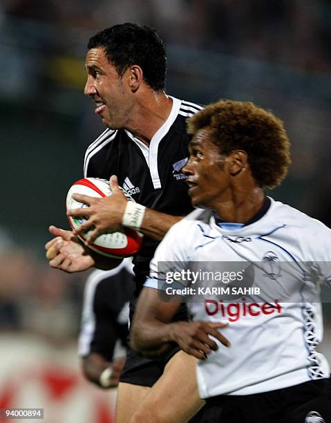 Fiji's Osea Kolinisau approaches New Zealand's Zar Lawrence as he advances with the ball during their IRB Rugby Sevens World Series semi-final match...