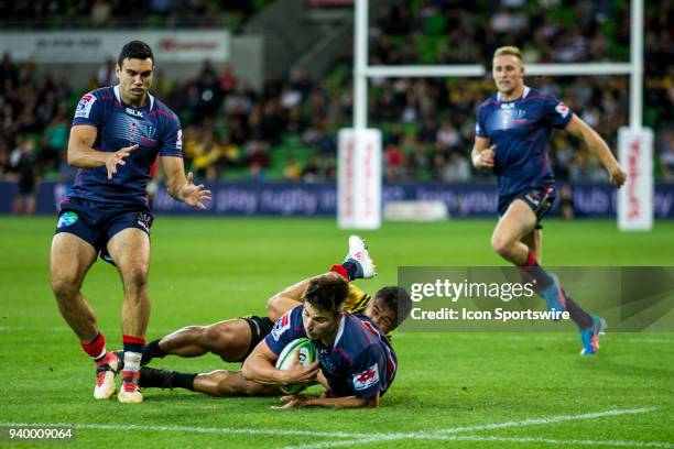 Jack Maddocks of the Melbourne Rebels is tackled by a Wellington Hurricanes player during Round 7 of the Super Rugby Series between the Melbourne...