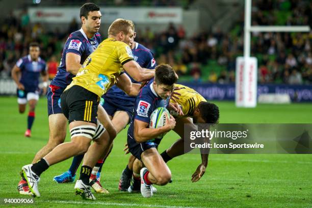 Jack Maddocks of the Melbourne Rebels is tackled by a Wellington Hurricanes player during Round 7 of the Super Rugby Series between the Melbourne...