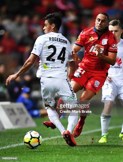 Logan Rogerson of Wellington Phoenix and Tarek Elrich of Adelaide United during the round 25 A-League match between Adelaide United and the...