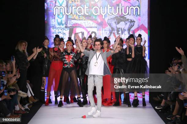 Designer Murat Aytulum and models acknowledge the applause of the audience after the Murat Aytulum show during Mercedes Benz Fashion Week Istanbul at...