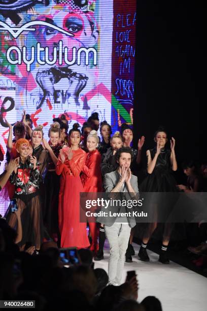 Designer Murat Aytulum and models acknowledge the applause of the audience after the Murat Aytulum show during Mercedes Benz Fashion Week Istanbul at...