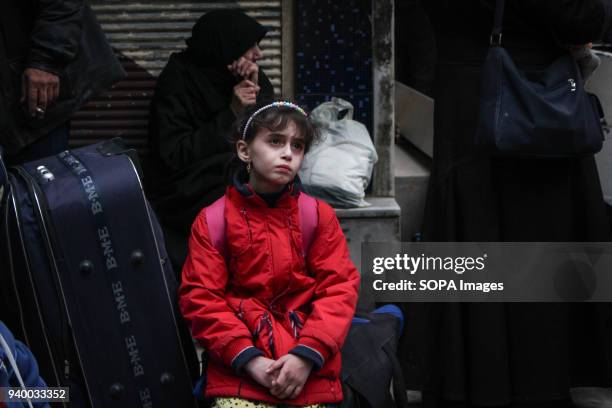 One of the girls who will go to Damascus sits on her bags and cries and remembers her city. According to reports, civilians, mostly ill people and...