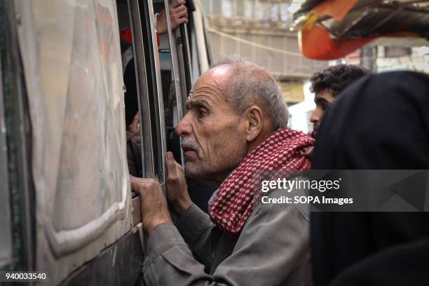 Man looking at his family for the last time after they were approved to leave for Damascus , According to reports, civilians, mostly ill people and...