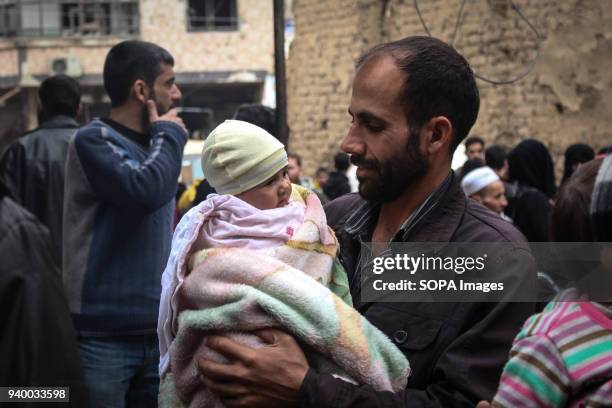 Father seen with his baby before getting on a evacuation bus. According to reports, civilians, mostly ill people and injured that need urgent medical...