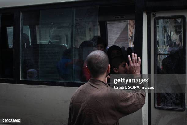 The man waving his hand to his daughter after being allowed to get out of the rebel areas to Damascus, According to reports, civilians, mostly ill...