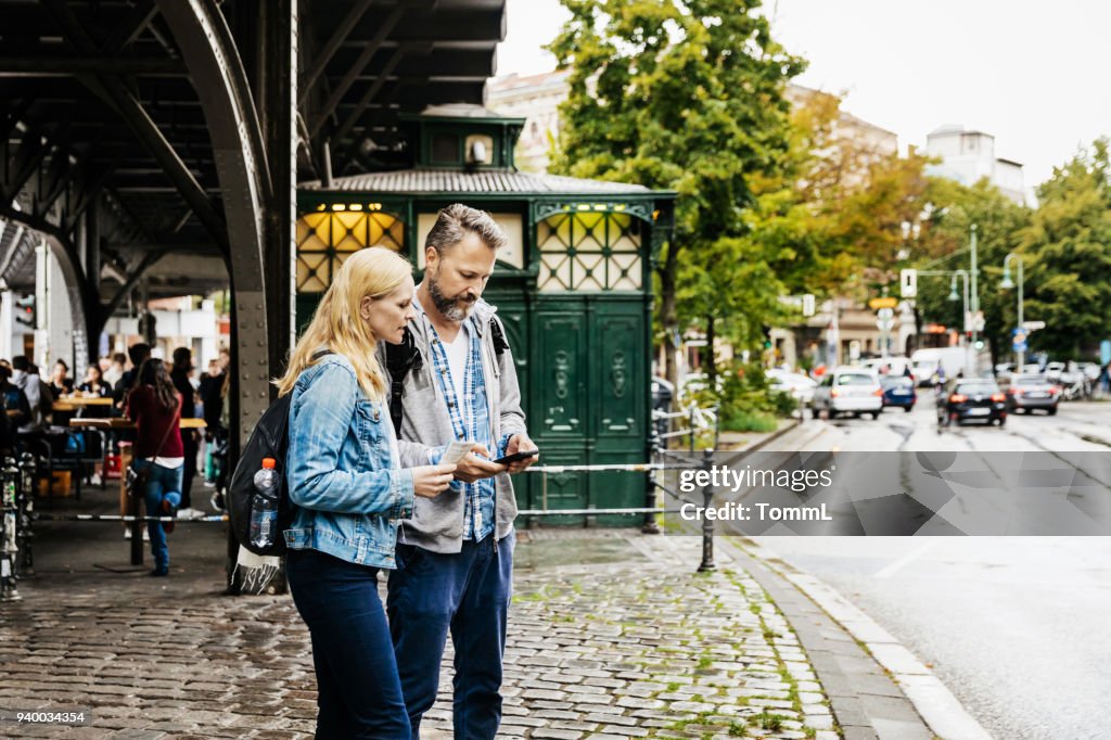 Tourist Couple Finding Their Bearings In New City