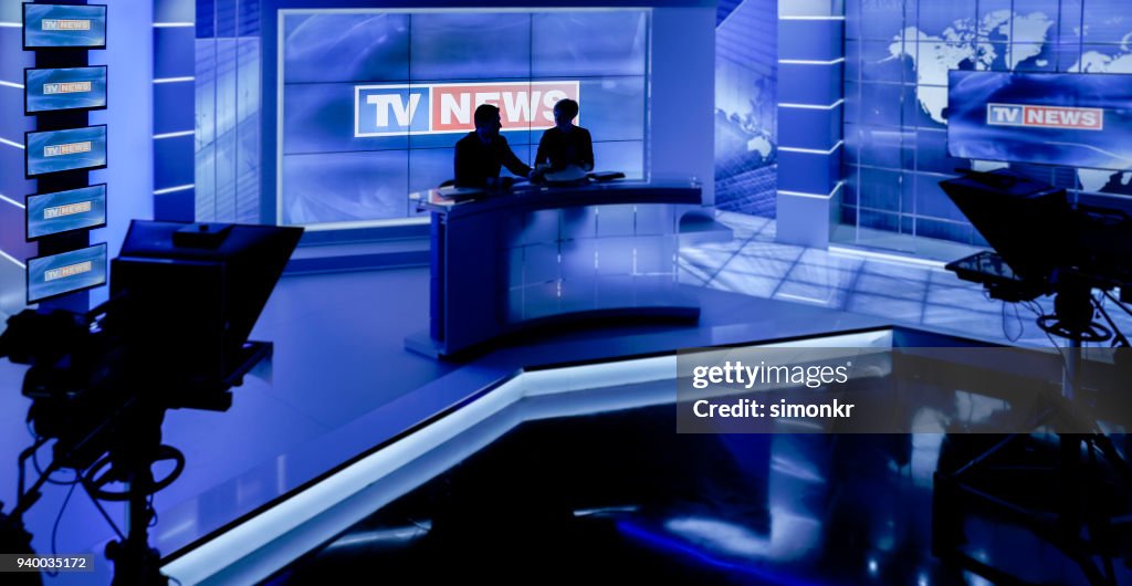 Newsreaders in television studio