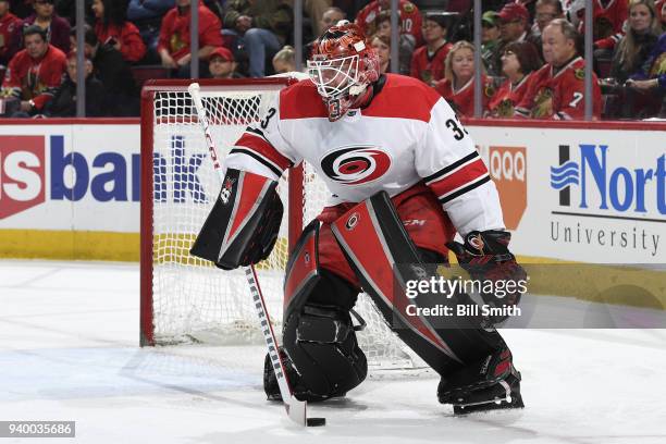 Goalie Scott Darling of the Carolina Hurricanes guards the puck in the first period against the Chicago Blackhawks at the United Center on March 8,...