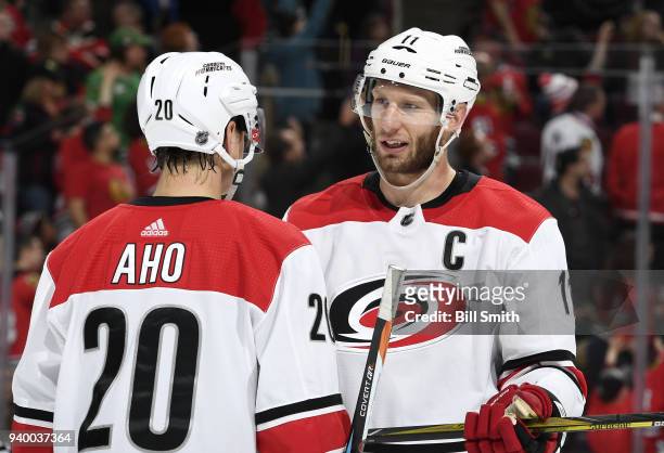 Jordan Staal of the Carolina Hurricanes talks with Sebastian Aho in the third period against the Chicago Blackhawks at the United Center on March 8,...