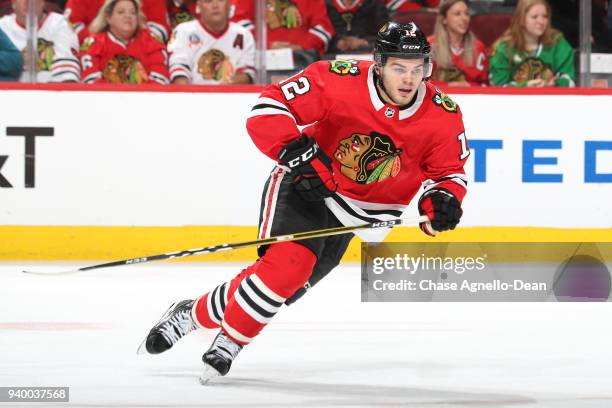 Alex DeBrincat of the Chicago Blackhawks skates in the second period against the Carolina Hurricanes at the United Center on March 8, 2018 in...