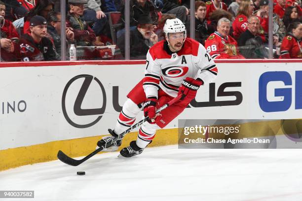 Justin Faulk of the Carolina Hurricanes approaches the puck in the second period against the Chicago Blackhawks at the United Center on March 8, 2018...
