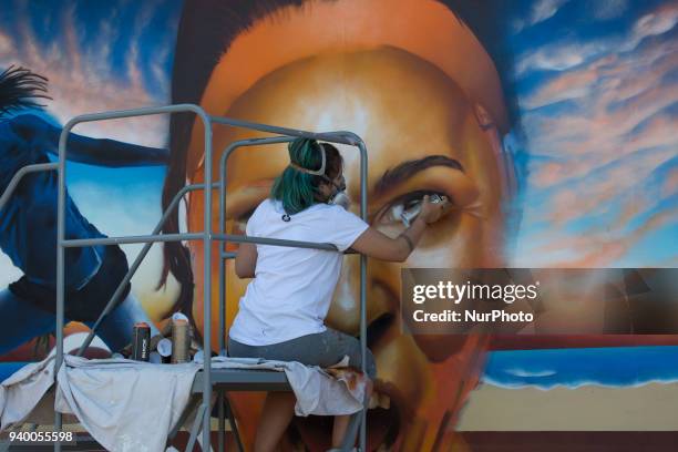 Graffiti artist Clara Leff, from Brazil, finishing her art mural at the Miami Open. Leff was commissioned by Bank Itau, the main sponsor of the...