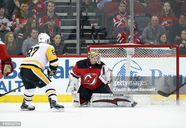 Sidney Crosby of the Pittsburgh Penguins hits the post in overtime prior to scoring the game winning goal against Keith Kincaid of the New Jersey...