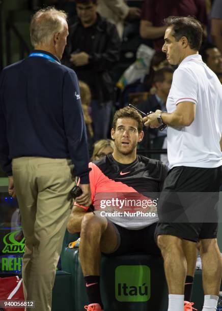 Juan Martin Del Potro, from Argentina, talking with a physiotherapist after feeling some pain during his quarter final match at the Miami Open. Del...