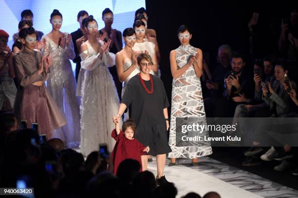 Designer Ozlem Erkan and models acknowledge the applause of the audience after the Ozlem Erkan show during Mercedes Benz Fashion Week Istanbul at...