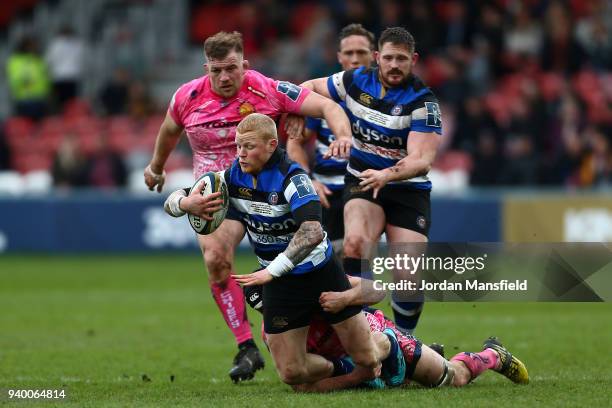 Tom Homer of Bath is tackled by Greg Holmes of Exeter Chiefs during the Anglo-Welsh Cup Final between Bath Rugby and Exeter Chiefs at Kingsholm...