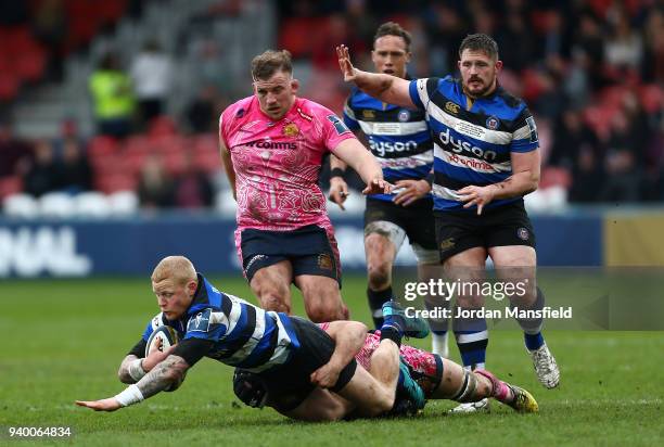 Tom Homer of Bath is tackled by Greg Holmes of Exeter Chiefs during the Anglo-Welsh Cup Final between Bath Rugby and Exeter Chiefs at Kingsholm...