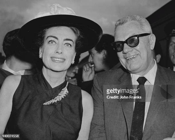 American actress Joan Crawford and her husband Alfred Steele arrive at Waterloo Station in London, 24th July 1956. Crawford is in the UK to star in...