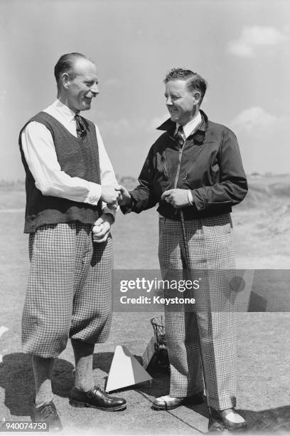 Golfer Leonard Crawley , a former English champion, shakes hands with Alex Kyle after defeating him at the 20th hole at Birkdale, UK, 29th May 1946.