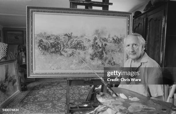 English painter Terence Cuneo works on his painting 'Ambush at Sanna's Post', July 1975. The work depicts an attack by Boer forces on the Q battery...