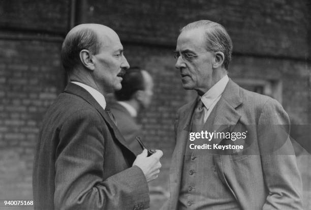British Prime Minister Clement Attlee talking to Sir Stafford Cripps in the garden of 10 Downing Street, London, 23rd August 1945.