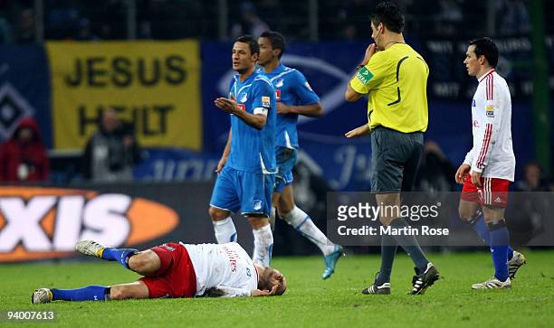 Mladen Petric of Hamburg lies injured on the pitch during the Bundesliga match between Hamburger SV and 1899 Hoffenheim at the HSH Nordbank Arena on...
