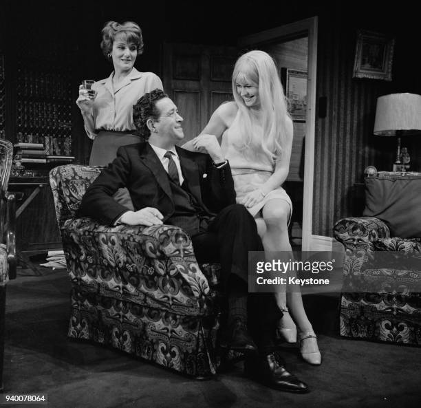 From left to right, actors Constance Cummings as Liza Foot, John Gregson as MP Joe Malkin and Wendy Varnals as a pop singer during a rehearsal for...