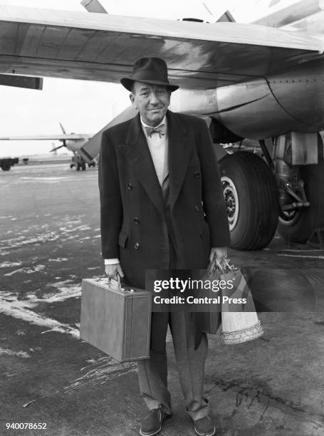 English actor and playwright Noël Coward arrives at London Airport from New York, 30th March 1954.