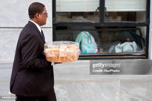 Bill Cosby's spokesperson Andrew Wyatt caries lunch during a March 29, 2018 pre-trial hearing at Montgomery County Courthouse, in Norristown, PA....