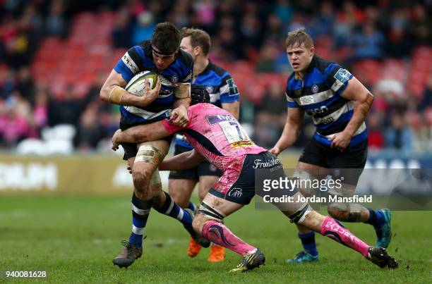 Josh Bayliss of Bath is tackled by Julian Salvi of Exeter Chiefs during the Anglo-Welsh Cup Final between Bath Rugby and Exeter Chiefs at Kingsholm...