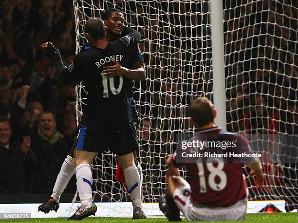 Antonio Valencia of Manchester United celebrates with Wayne Rooney as he scores their third goal as Jonathan Spector of West Ham United looks...