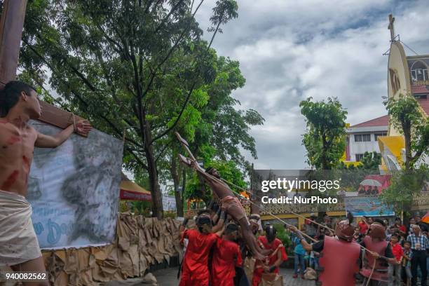 Indonesian Catholic devotees participate in a re-enactment of the crucifixion of Jesus Christ on Good Friday procession at Church of Santa Maria A....