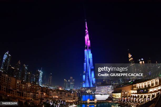 Picture taken on March 29, 2018 shows a laser show on the Burj Khalifa, the tallest tower in the world, in downtown Dubai.