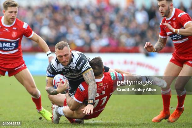 Josh Griffin of Hull FC is tackled by Maurice Blair of Hull KR during the BetFred Super League match between Hull KR and Hull FC at KCOM Craven Park...