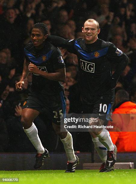 Antonio Valencia of Manchester United celebrates with Wayne Rooney as he scores their third goal during the Barclays Premier League match between...