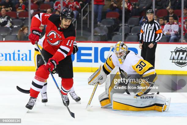 New Jersey Devils center Brian Boyle and Pittsburgh Penguins goaltender Matt Murray during the first period of the National Hockey League game...