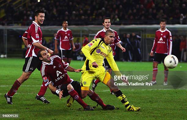 Mohamed Zidan of Dortmund is defended by Javier Pinola of Nuernberg during the Bundesliga match between Borussia Dortmund and 1. FC Nuernberg at...