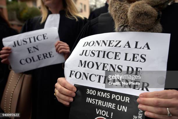Judge shows a placard reading 'Give Justice the means to operate'.The French Bar Association, all lawyers' unions, all magistrates' unions called all...