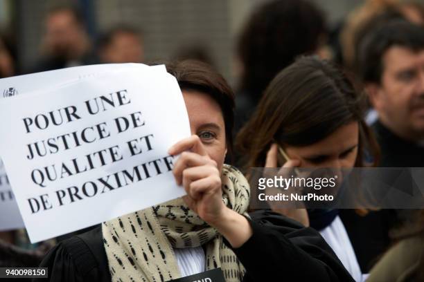 Lawyer brandishes a placard reading 'For a Justice of quality and proximity'. The French Bar Association, all lawyers' unions, all magistrates'...