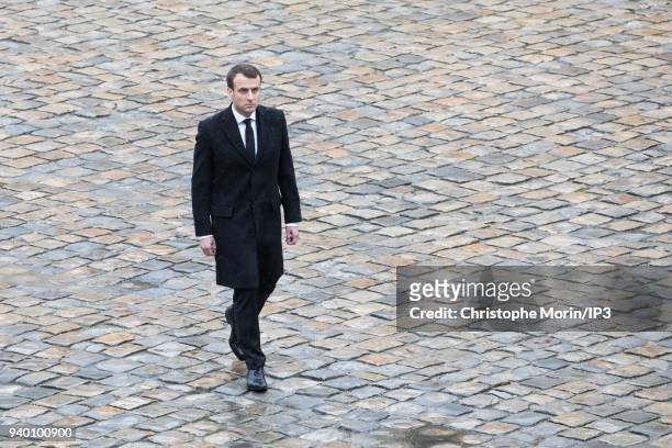 President of the Republic Emmanuel Macron attends a national tribute to Colonel Arnaud Beltrame at Hotel des Invalides on March 28, 2018 in Paris,...
